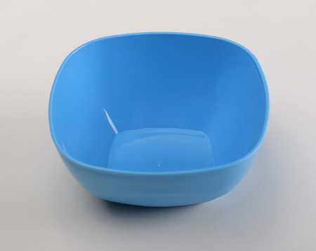 Blue plastic deep dish isolated on white backgroundの写真素材
