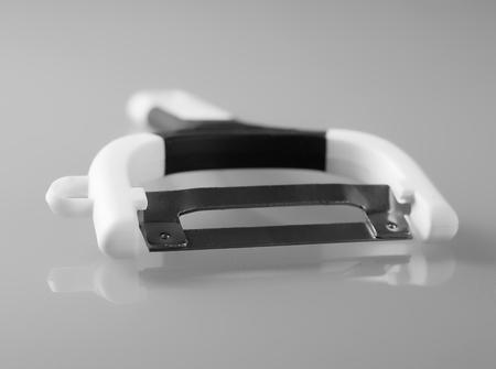Close up of potato peeler on gray background