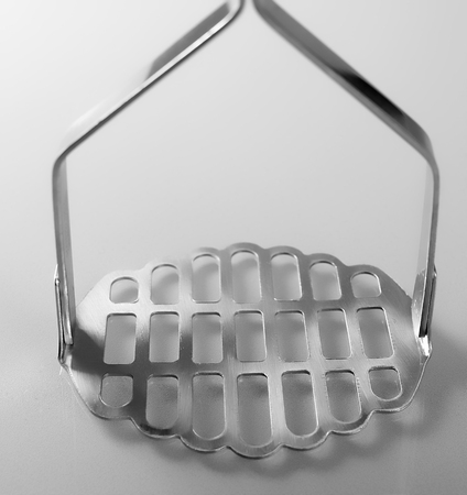 Close up of potato masher isolated on white backgroundの写真素材