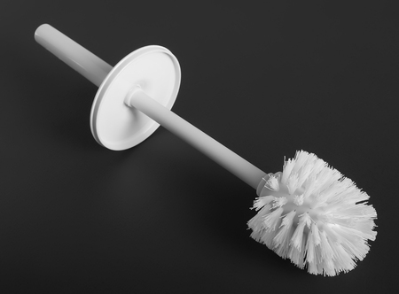 White plastic toilet brush on gray backgroundの写真素材