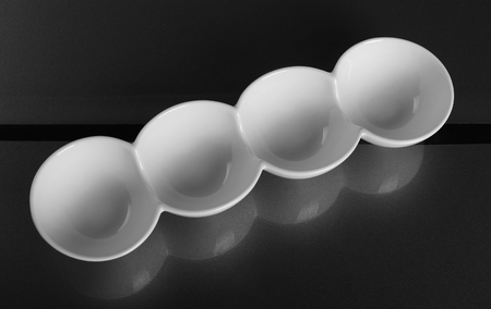 Round porcelain bowl with four compartmentsの写真素材