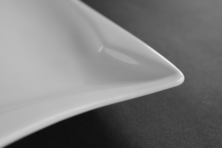 Detail of deep square porcelain dish. White bowlの写真素材