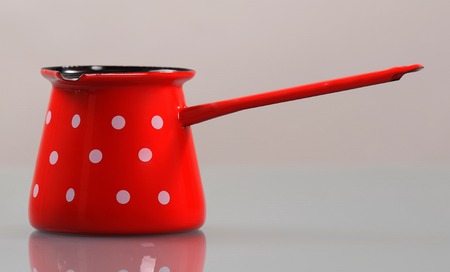 Enameled pot with black interior and long handle for making turkish coffeeの写真素材