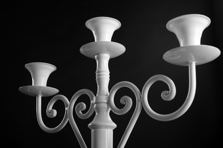 Antique white candlestick isolated on black backgroundの写真素材