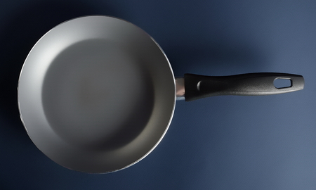Frying pan on blue background perfect for your delicious recipes, top viewの写真素材