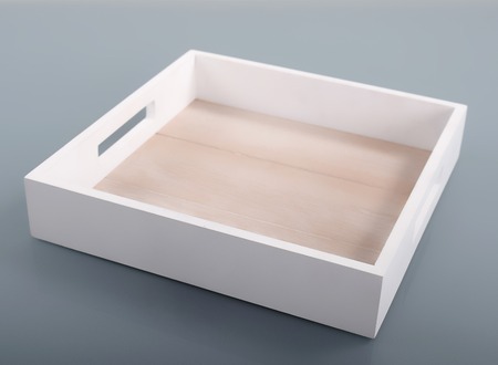 White wooden tray on gray background