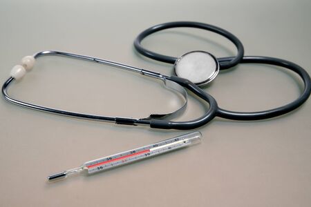 Medical thermometer and stethoscope on the table. Medical equipmentの写真素材