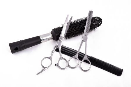 Scissors, brush and comb on white backgroundの写真素材