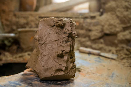 Abstract pieces of wet clay on the table. Wet white clay closeup