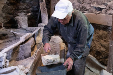 Old mill for grinding grain up close. The miller grinds grain in its mill