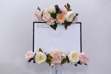 Sign placed on a board in front of the restaurant entrance. Welcome table board sign at the wedding on the restaurant with welcoming romantic words invitation for the guestsの写真素材