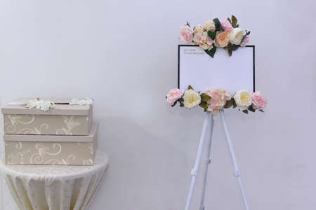 Sign placed on a board in front of the restaurant entrance. Welcome table board sign at the wedding on the restaurant with welcoming romantic words invitation for the guestsの写真素材