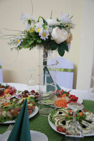 A big glass vase with wedding flowers on the table. Wedding conceptの写真素材