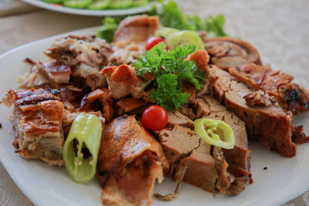 Roast pork loin with cucumber, pepper and radish salad. Grilled pork neck served with sliced pepper,...