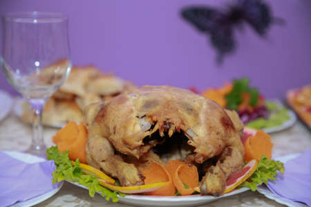 Grilled chicken lays on a white plate.の写真素材