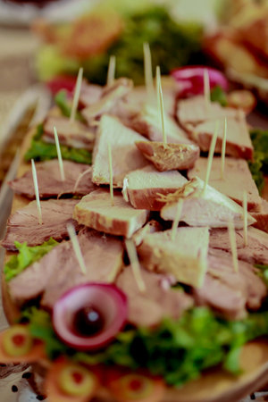 Food tray with roast pork, chopped into small pieces and served for a wedding celebration at the tableの写真素材