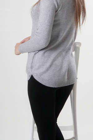 Girl in black leggings and light gray blouseの写真素材