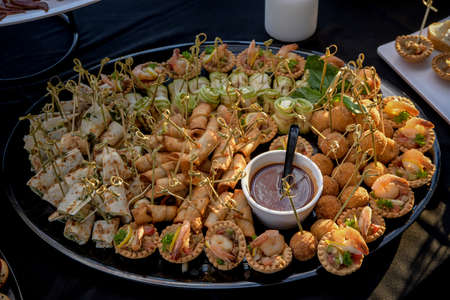 Food tray with delicious and different wrap meals with delicious salami, pieces of sliced ham, sausageの写真素材