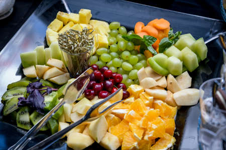 A mixture of fresh fruit, decorated in a bowl of tableの写真素材