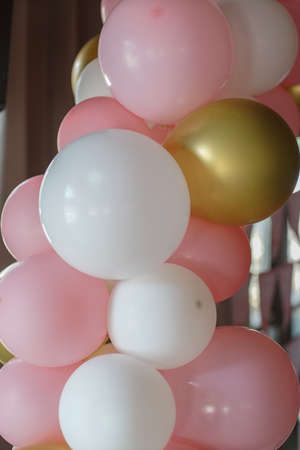 Many colorful balloons decorated wall as background. Beautiful background with colorful balloons. Birthday style partyの写真素材