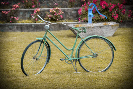 Green bicycle garden decoration. Old bicycle in the park. Retro styleの写真素材