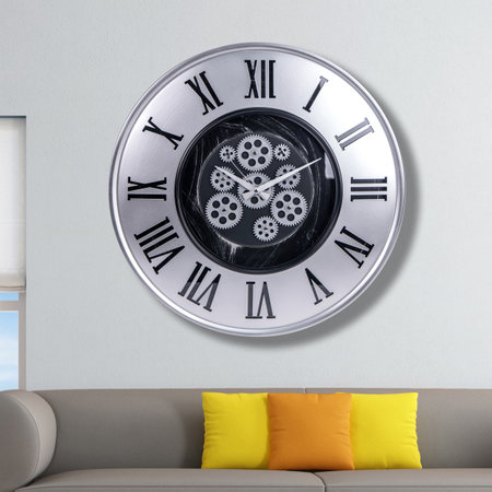 A large round indoor clock on the wall. Big clock on metal rack. Big clock hanging on white wall. Time concept. Antique clock hanging on the living room wallの写真素材