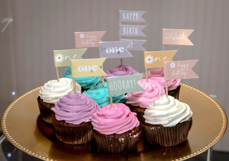 Tasty cupcakes with flags. Creative food composition. Butter cupcake muffin with cream frosting sprinkles on the tableの写真素材