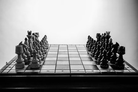 Chess board game concept of business ideas and competition and strategy ideas concept. Chess pieces before the game. Chess board on the table. View with chess pieces on a chess tabの写真素材