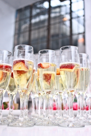 Filled champagne glasses arranged on a tableの素材