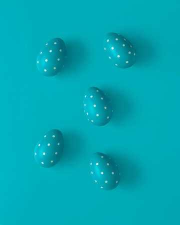 Blue punctate Easter eggs on blue background. Creative Spring concept, flat lay.の写真素材
