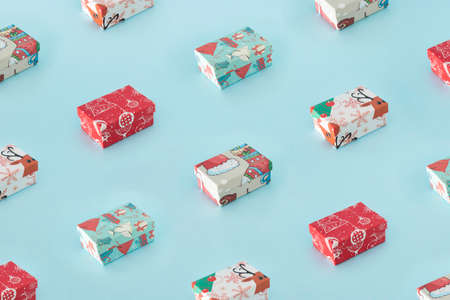 Winter creative pattern concept of colorful Christmas present boxes on pastel blue background. New...