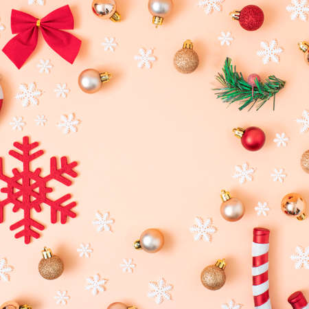 Christmas composition. Red and gold decorations on pastel pink background. Christmas, winter, new year concept. Flat lay, top view, copy space.の写真素材