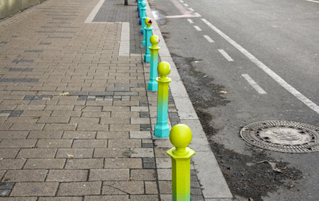 Green and yellow poles on the road, closeup of photoの写真素材