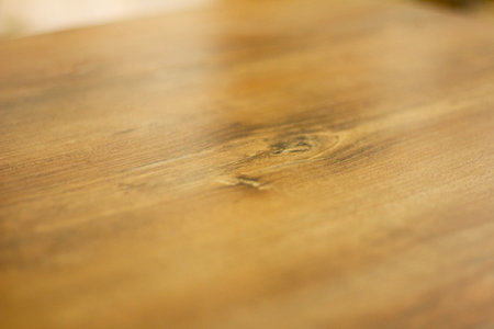 Wooden table top in the kitchen. Selective focus with shallow depth of field.の写真素材