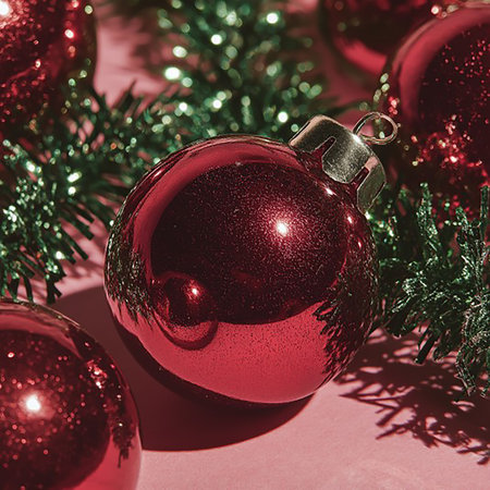 Christmas balls and spruce branch on a pink background. tintedの素材