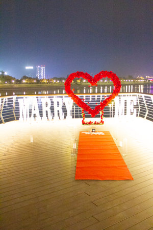 Red carpet in the shape of a heart on the bridge at nightの写真素材