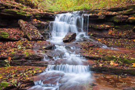 Beautiful waterfall on a mountain stream in the woodsの写真素材