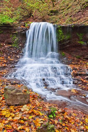 Beautiful waterfall on a mountain stream in the woods