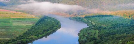Beautiful summer panoramic landscape with morning fog over the river. Dniester Canyon, Ukraine, Europeの写真素材