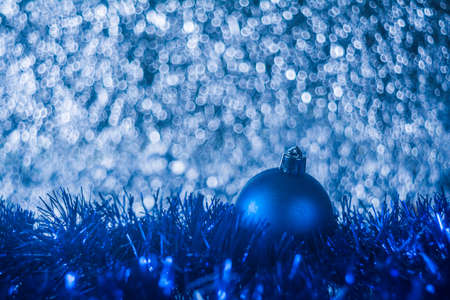 Christmas ball on blue abstract bokeh backgroundの写真素材