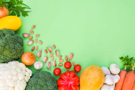 Fresh ripe organic vegetables on a light green backgroundの写真素材