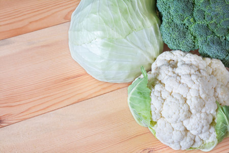 Assorted cabbage on a wooden background. White cabbage, cauliflower and broccoliの写真素材