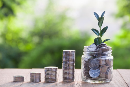 Columns of coins and accumulations of coins in a glass jar. The concept of financial growth. The...