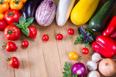 Fresh ripe organic vegetables on a wooden tableの写真素材