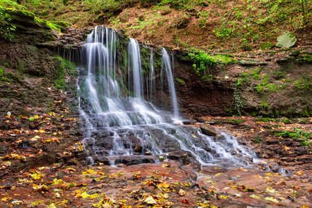 Picturesque waterfall on a mountain stream in a forest. One of the cascade of Rusiliv waterfalls. Rusylov, Ternopil region, Ukraineの写真素材