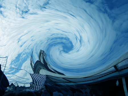 A cloud in the shape of a curl above the building of a futuristic form.  .の写真素材