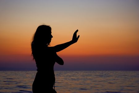 A young woman exercising at the beachの写真素材