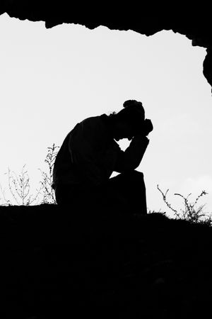 Silhouette of a man contemplatingの写真素材