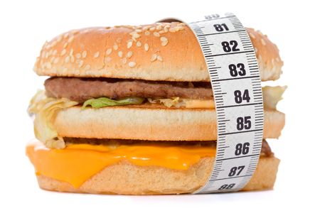 Hamburger wrapped around a measurement tape against white backgroundの写真素材