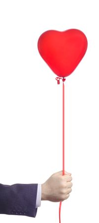 Hand holding a red balloon against white background の写真素材